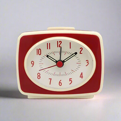 Red and beige alarm clock on a white background