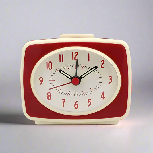 Red and beige alarm clock on a white background