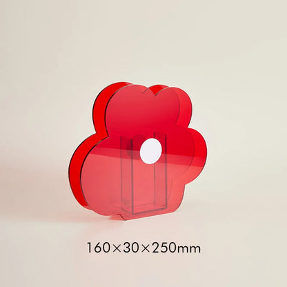 A red flower shaped vase on a white background