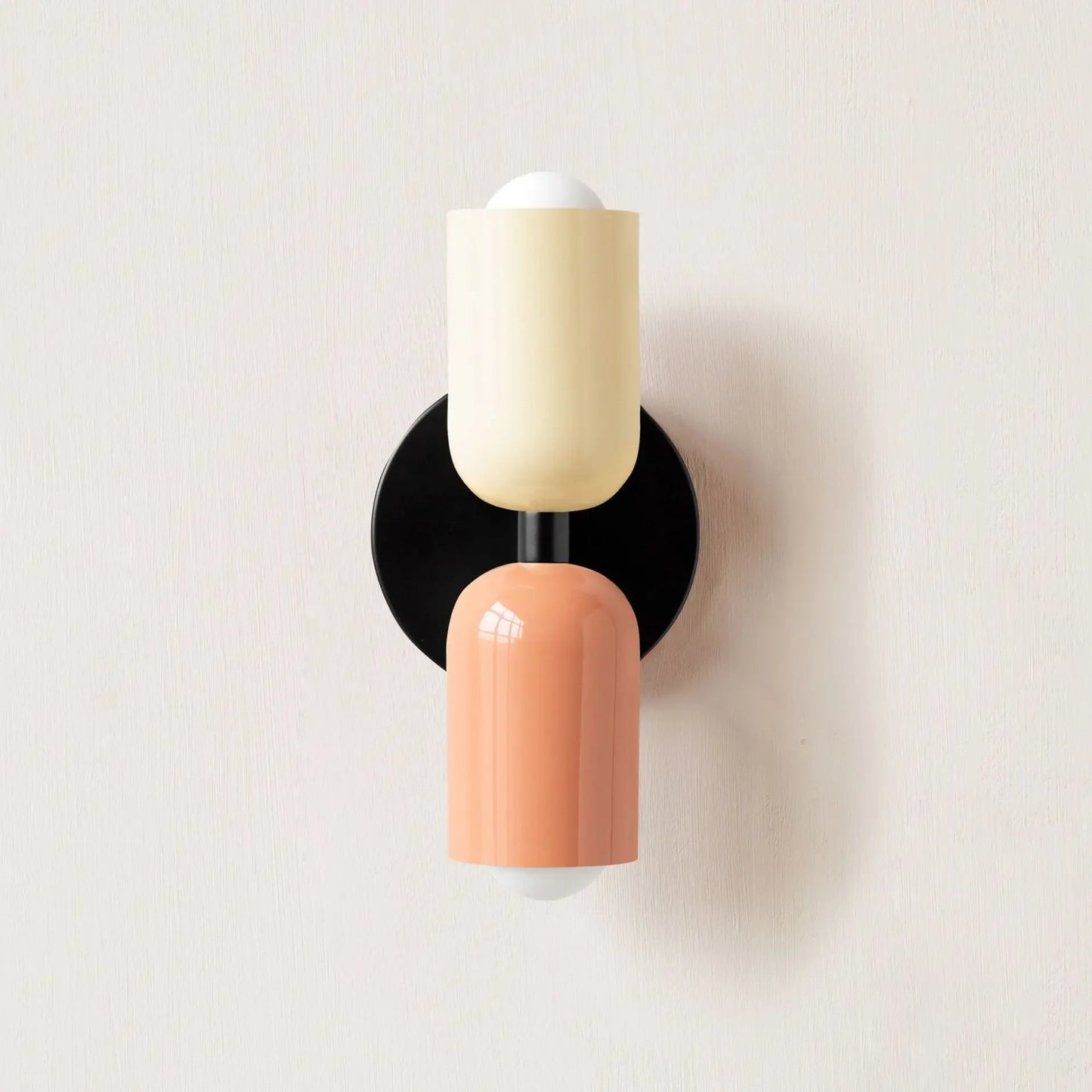 Wall sconce with two-tone design on a light background
