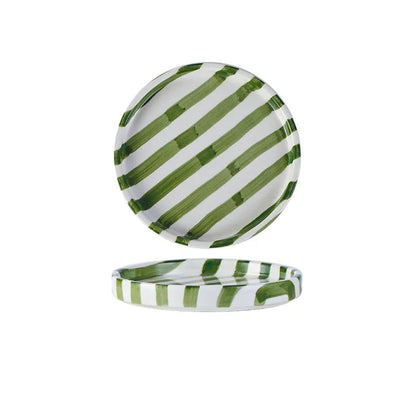 Green and white striped ceramic plate with measurements on a white background