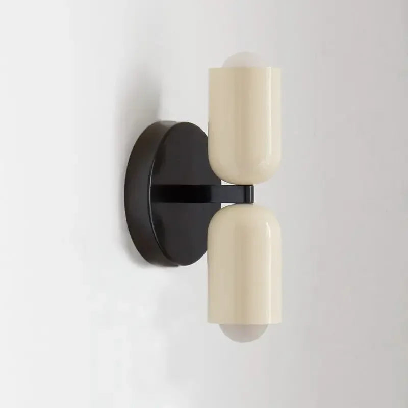 Wall-mounted light fixture with black and beige design on a white background