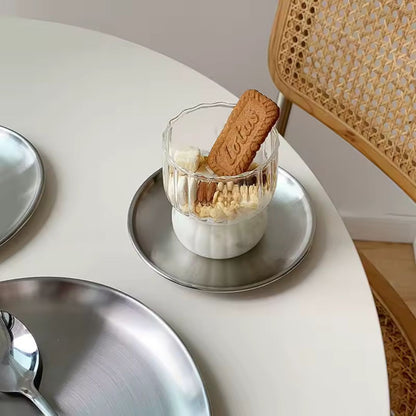 Glass dessert with a cookie on a white table