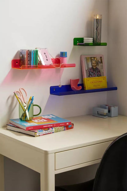 Desk with colorful shelves and stationery items in a home office setting