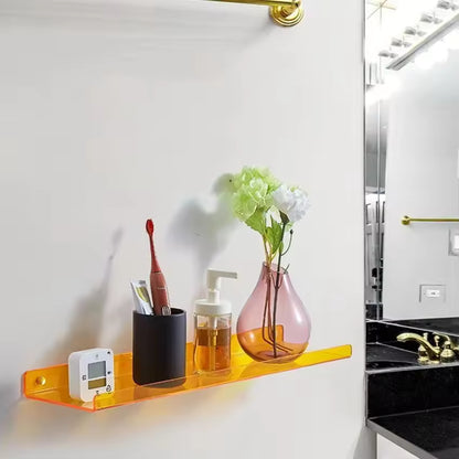 Bathroom shelf with toiletries and a vase on a white wall.