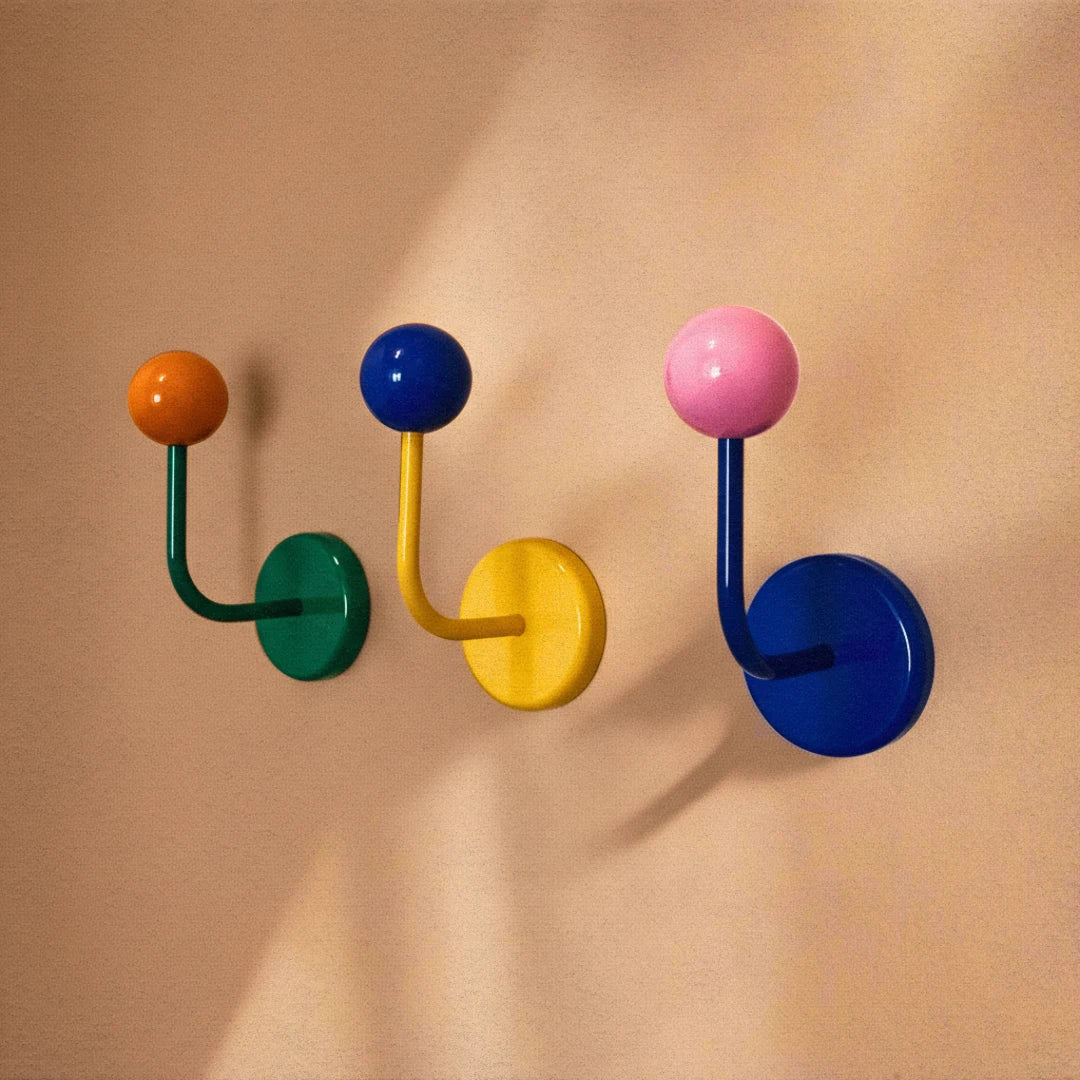 Colorful wall hooks on a beige wall