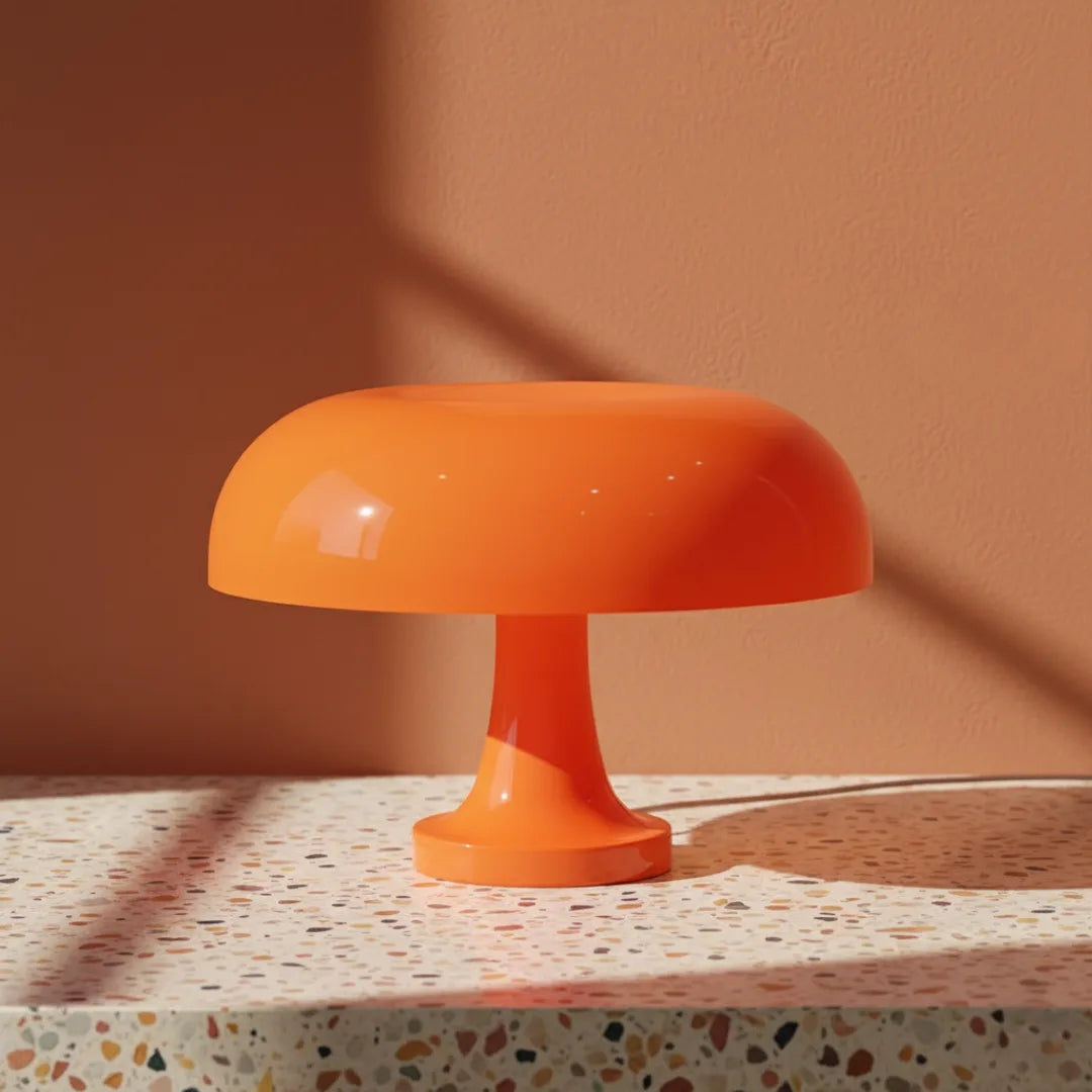 Orange lamp on a terrazzo surface with a warm brown background