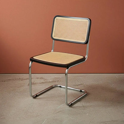 Chair with wicker seat and backrest against a brown wall