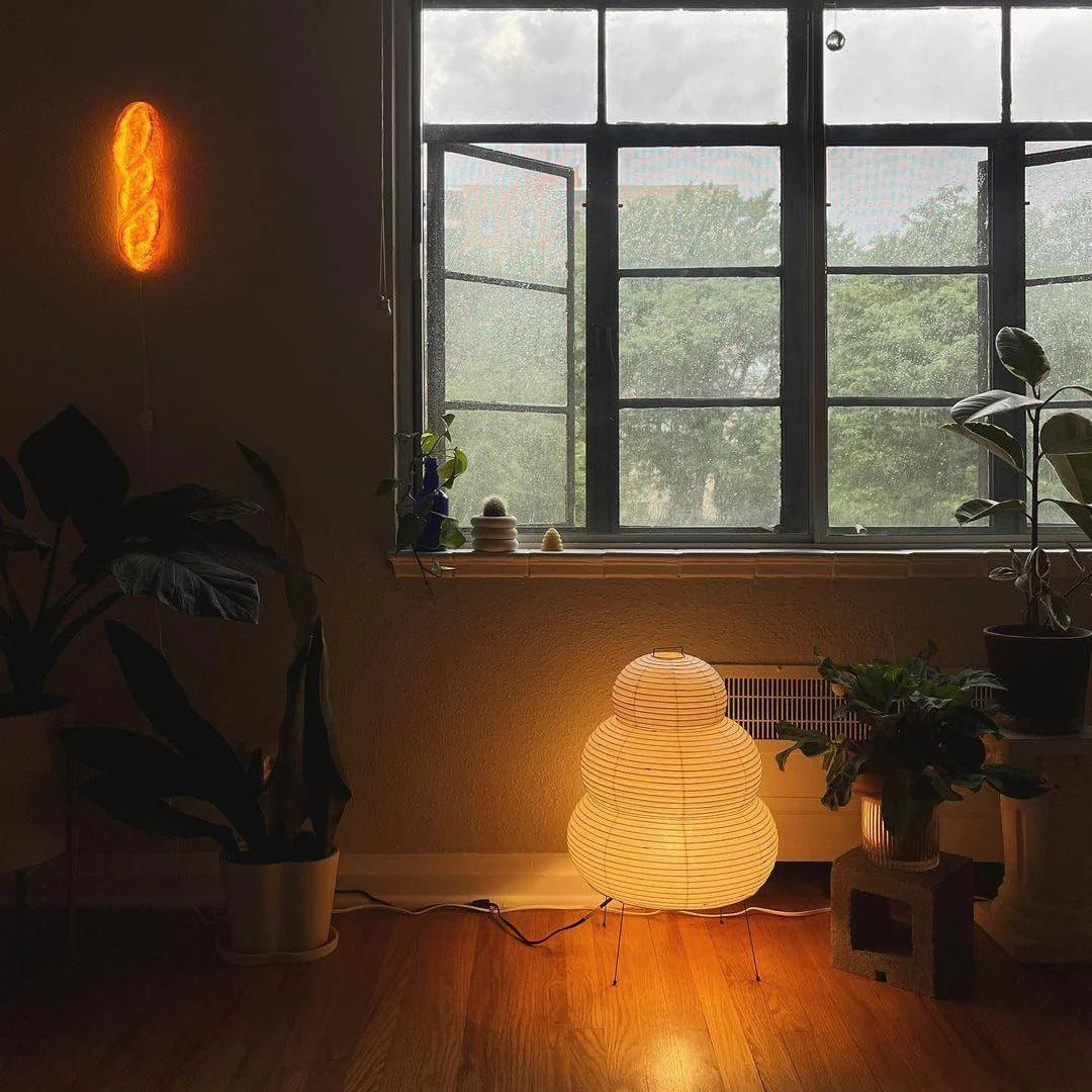 Room interior with a glowing lamp, window, and plants