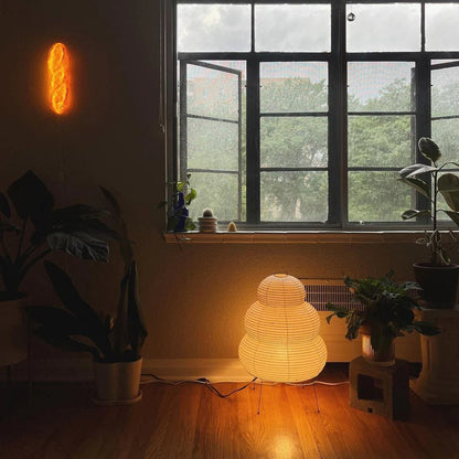 Room interior with a glowing lamp, window, and plants