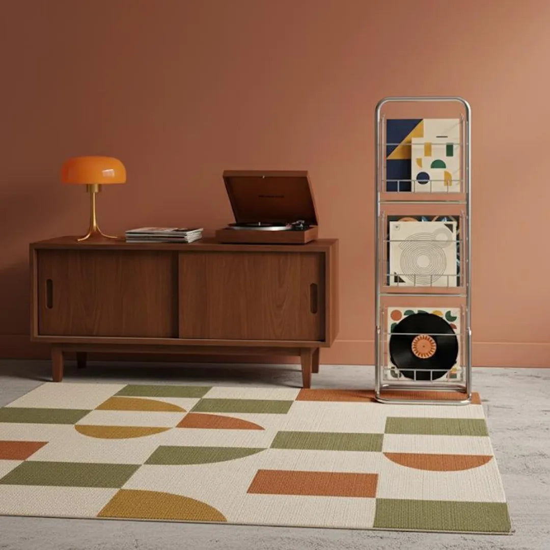 Wooden sideboard with vinyl record player, lamp, and record album in a room with a geometric-patterned rug.