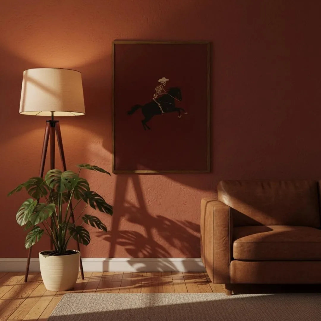 Living room with a brown sofa, lamp, plant, and framed picture on a red wall.