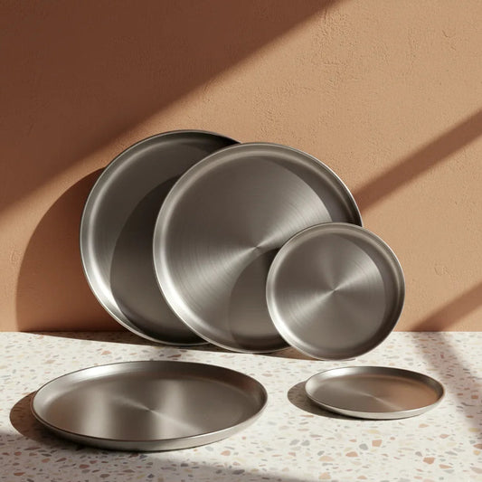 Set of metallic plates on a textured surface with a warm background