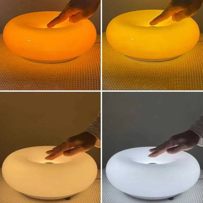 Collage of a glowing ring-like object with a hand interacting with it, shown in four different colors.